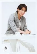 V6 / Junichi Okada / Above-the-knee ・ Costume white ・ Sitting ・ Two handed PC ・ Gaze right ・ Background white / Official Official photo