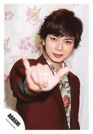 Arashi / Matsujun / Upper body / Jacket red / Shirt green yellow red / Right finger spread front / On the background wall "Arashi BLAST" / Official Official photo