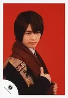 Johnnys Jr. / Genki Iwahashi / Bust up / Costume black / Scarf with both hands / Body facing right / Background red / Official Official photo