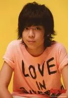 SeXyzone / Satoshi Matsushima / Upper body ・ T-shirt pink ・ "LOVE IN" ・ Background yellow ・ Logo "SeXyzone" ・ No frame / Official Official photo