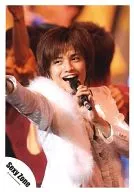 SeXyzone / Ken Nakajima / Live Photo / Upper Body / Costume White / Left Hand Microphone / Mouth Open / Eye View Left / Background Orange / Official Official photo