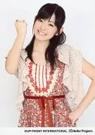 ° C-ute / Airi Suzuki / Upper Body / Costume red / Beige / Right Hand Fist / Left Hand Hip / Face Tilt / White Background / Official Official photo