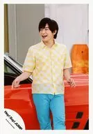 Hey! Say! JUMP / Yuri Chinen / Above-the-knee / Shirt Yellow-White Check Pattern / Pants Blue-green / Both Hands Up / Face Left / Mouth Open / Background Car Red / "Kirakira Hikaru" PV Off-Shot / Official Official photo