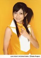 Berryz Kobo / Yurina Kumai / Upper Body / Costume Yellow White / Left Hand Breast / Right Hand Lower / Body Right Facing / Background Yellow / Official Official photo