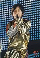 V6 / Junichi Okada / Live photo / Upper body / Costume gold / Left hand microphone / Background screen / Logo "10th Anniversary" / 10th Anniversary