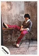 Jin Akanishi / Whole body, Shirt-gray, Pants red, Sitting in a chair, Legs stretched / ・ Logo "JIN AKANISHI" / Official Official photo