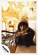 Jin Akanishi / Hoodie sitting at table / Knife and fork in right hand / Lower left "JIN AKANISHI" logo / Official Official photo