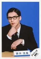 Johnny's West / Ryusei Fujii / Bust up, sitting, costume black, white, suit, glasses, right hand chin, background blue / "Johnny's West LIVE TOUR 2019 WESTV!" goods off-shot / official Official photo