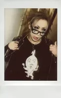 The Raid. / Ichiyo / Bust up / Costume black / Glasses / Right hand shoulder stiffness / Left hand thumb standing / Eye point right / Tongue out / Raw Cheki