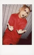 The Raid. / Ichiyō / Knee-Up / Sitting / Red costume / Bending both hands / Chin up / Face facing right / Showing teeth / Raw Cheki