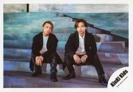 KinKi Kids / Domoto Go ・ Domoto Koichi / horizontal ・ whole body ・ stair sitting ・ costume white ・ black ・ hard double layered ・ mouth closing / single "Sign of Light" MV & Jacque-shot off-shot / official Official photo