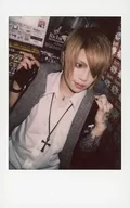 Axkey/AST / Upper Body / Costume Black / White / Check / Facing Right / Both Hands Shoulders / Right Hand Carrying / Eye Line Right / Raw Cheki