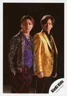 KinKi Kids / Koichi Domoto, Tsuyoshi Domoto / Above-knee ・ Costume brown ・ Purple ・ Gold ・ Black ・ Under both hands ・ Facing right ・ Eye left ・ Background black / Single "KANZAI BOYA" MV off-shot / Official Official photo